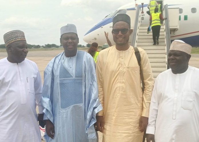 Adamawa APC chairman flanked by state officials of the party upon arrival at Yola Int'l airport, Tuesday.