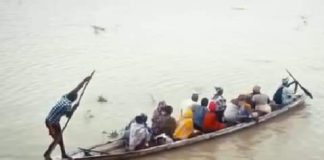 File picture of people crossing a river in a boat.