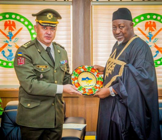 Nigeria's defense minister with Ukraine's defence attache in Nigeria.
