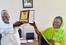 Chairman of CITN Yola and district society, Abubakar Bobboi receiving the merit award on behalf of the BIR exec chairman Hamman Adama Njabari, on Tuesday in Yola.