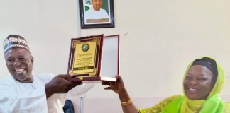 Chairman of CITN Yola and district society, Abubakar Bobboi receiving the merit award on behalf of the BIR exec chairman Hamman Adama Njabari, on Tuesday in Yola.