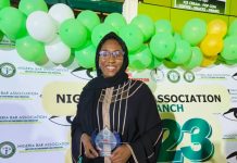 Raji in a pose with her award.