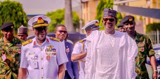 Bello alongside one of the newly decorated Navy officers