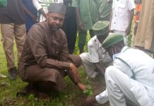 Medical Director FMC Birnin Kudu Dr. Adamu Abdullahi Atterwahmie planting a tree during the Flagg off of mass tree planting at the new site of the facility in B/kudu on Tuesday.