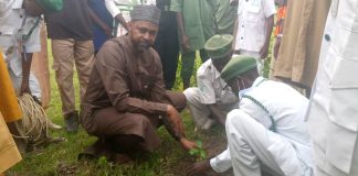 Medical Director FMC Birnin Kudu Dr. Adamu Abdullahi Atterwahmie planting a tree during the Flagg off of mass tree planting at the new site of the facility in B/kudu on Tuesday.
