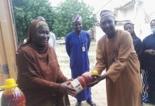 The FMC Birnin Kudu head clinical services Dr Halima Ibrahim Umar presenting foodstuffs to Malam Garzali Suleiman,a member of the hospital's Liberty Cooperative Society in Birnin Kudu on Thursday.