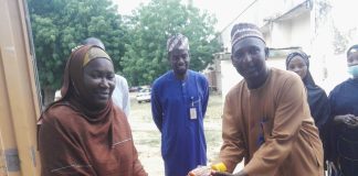 The FMC Birnin Kudu head clinical services Dr Halima Ibrahim Umar presenting foodstuffs to Malam Garzali Suleiman,a member of the hospital's Liberty Cooperative Society in Birnin Kudu on Thursday.