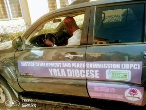 Elated Bishop Mamza test running the SUV donated to JDPC by Emnamu foundation.