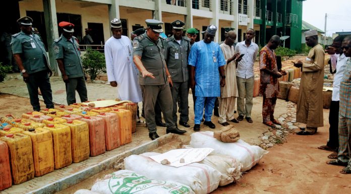 Garba Bashir, Adamawa/Taraba area commander of NCS inspecting some of the seized items on Tuesday at Customs house, Yola.
