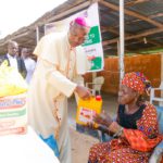 Mamza distributing the items to a victim of the clash.
