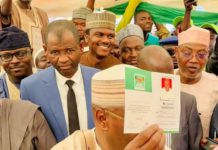 Atiku displaying his ADC membership card.