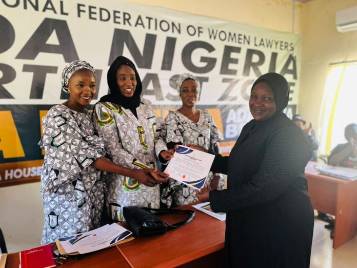 Barr Lubna M Dodo receiving her certificate of return after swearing in as chairperson of Adamawa State branch of FIDA on Friday.