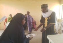 Ibrahim Abubakar Jimeta donating cash to a beneficiary on Sunday in Yola.