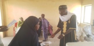 Ibrahim Abubakar Jimeta donating cash to a beneficiary on Sunday in Yola.