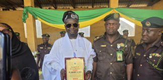Dr. Emmanuel flanked by Correctional service staff with the award giving to him on Tuesday in Yola.